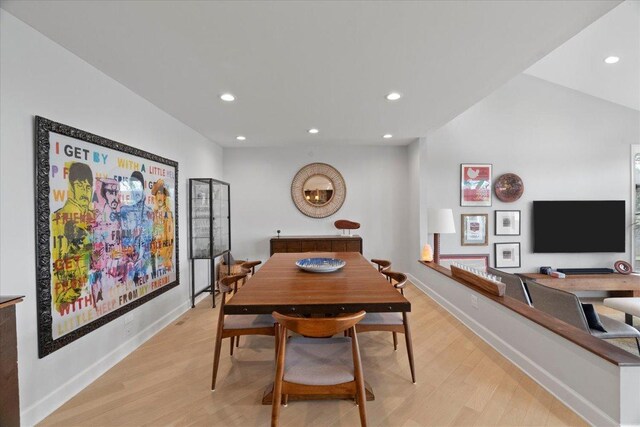 dining room with recessed lighting, baseboards, and light wood-type flooring