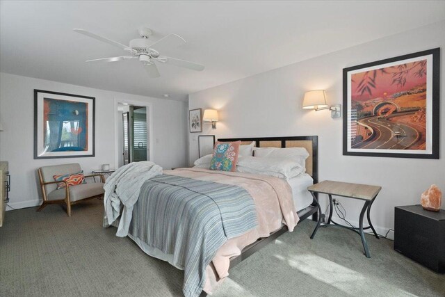 carpeted bedroom featuring baseboards and a ceiling fan