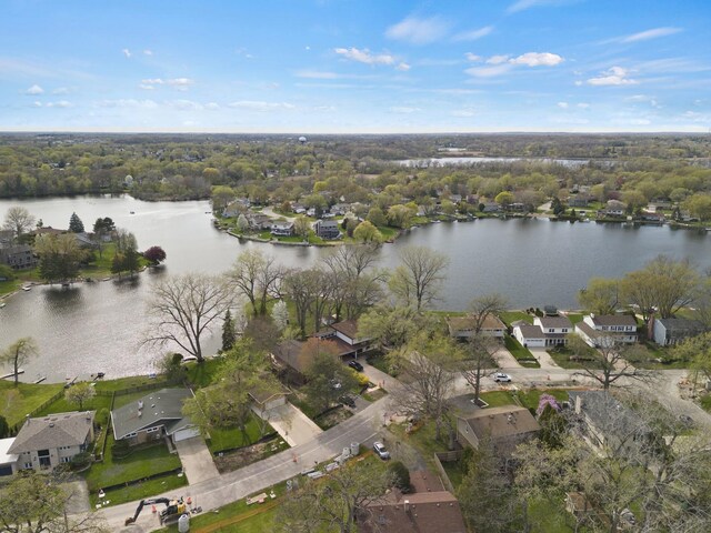 drone / aerial view featuring a water view and a residential view