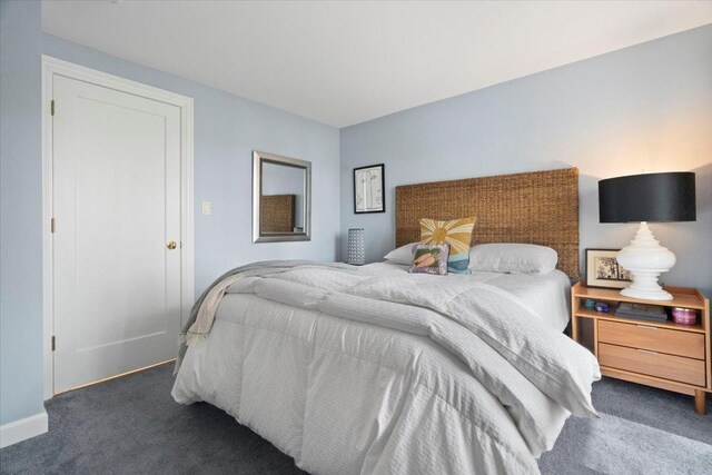 carpeted bedroom with baseboards