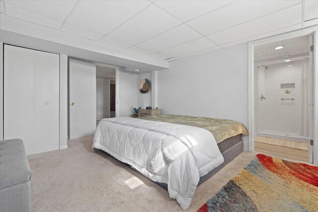 carpeted bedroom with connected bathroom, recessed lighting, and a paneled ceiling