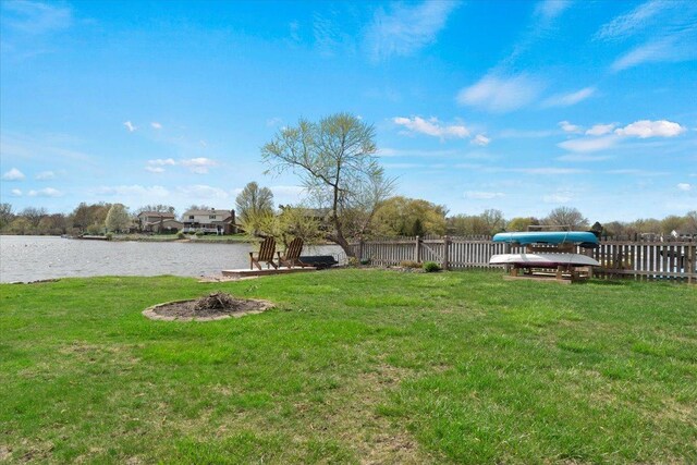 view of yard with fence and a water view