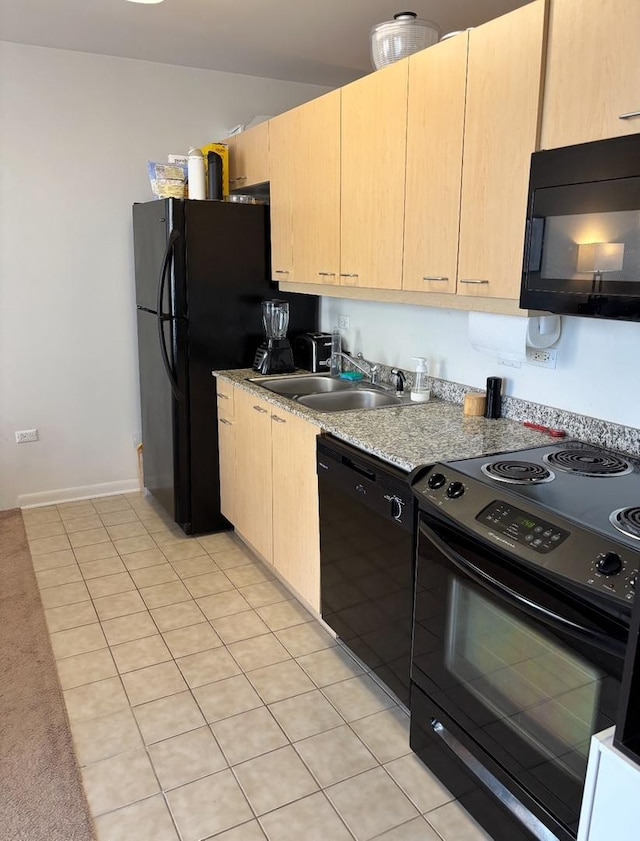 kitchen featuring light brown cabinetry, a sink, light countertops, light tile patterned floors, and black appliances