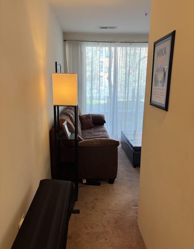 sitting room featuring carpet flooring and visible vents