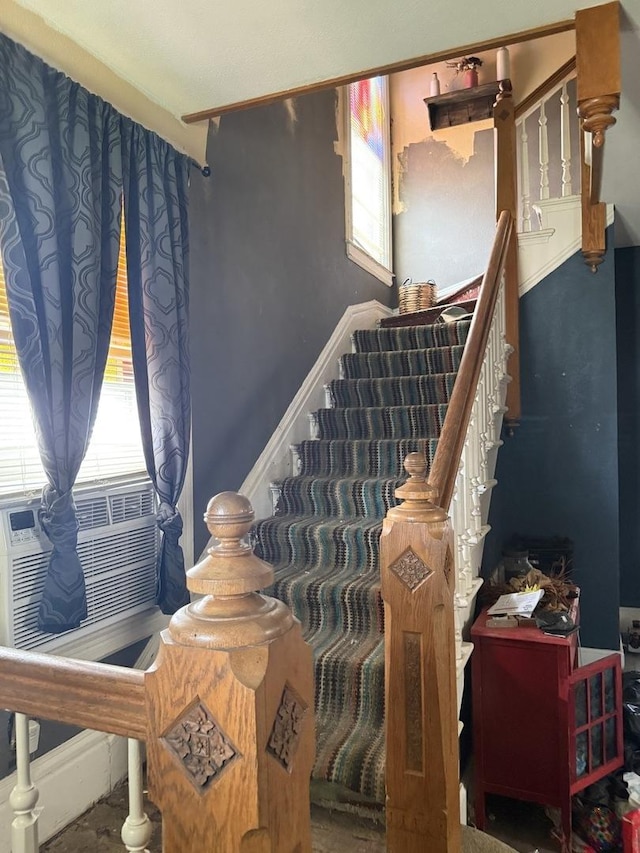 stairway with baseboards and cooling unit