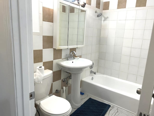 full bath with bathing tub / shower combination, toilet, and tile walls