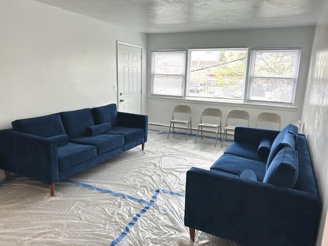 living room with a textured ceiling and baseboard heating