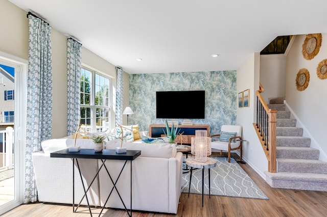 1909 Neubauer Cir Unit 1001, Lindenhurst, IL 60046 - living area with wallpapered walls, an accent wall, stairway, wood finished floors, and baseboards