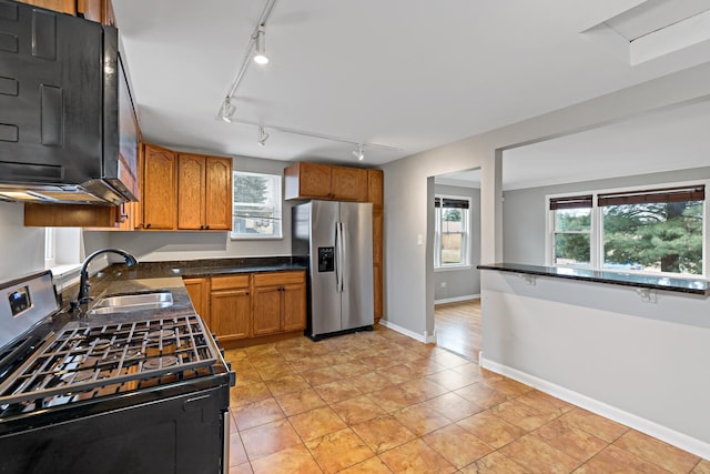 2724 W 96th Pl, Evergreen Park, IL 60805 - kitchen with a sink, appliances with stainless steel finishes, brown cabinets, and rail lighting