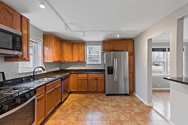2724 W 96th Pl, Evergreen Park, IL 60805 - kitchen with a sink, appliances with stainless steel finishes, brown cabinetry, and rail lighting