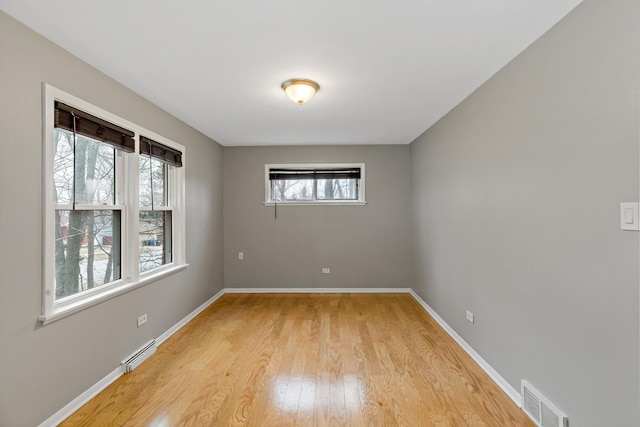 2724 W 96th Pl, Evergreen Park, IL 60805 - spare room featuring visible vents, a baseboard radiator, light wood-style floors, and baseboards