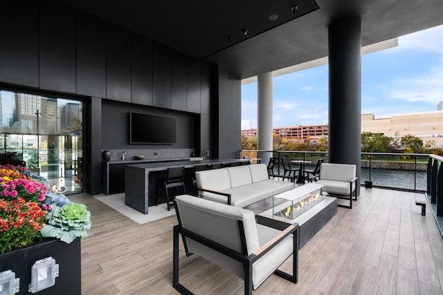 wooden deck with an outdoor living space with a fire pit