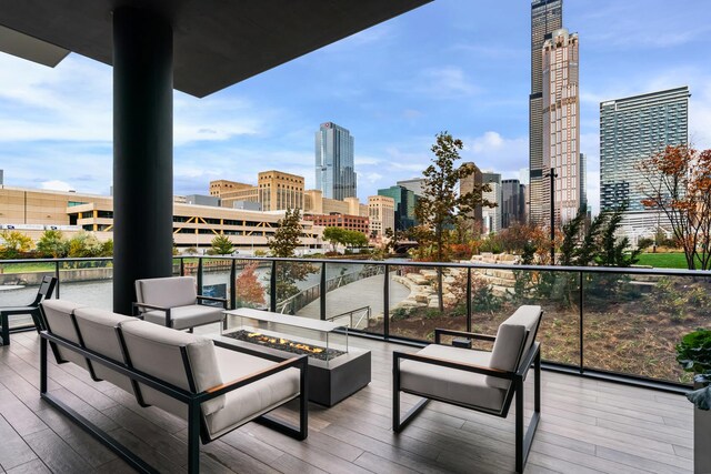 balcony featuring a view of skyline and an outdoor living space