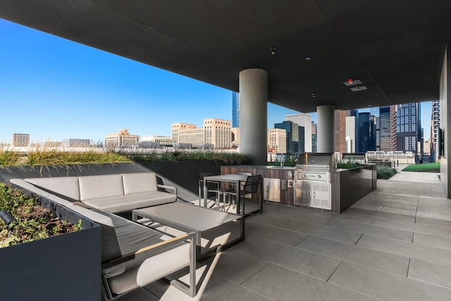 view of patio featuring exterior kitchen, a city view, an outdoor hangout area, a sink, and a grill