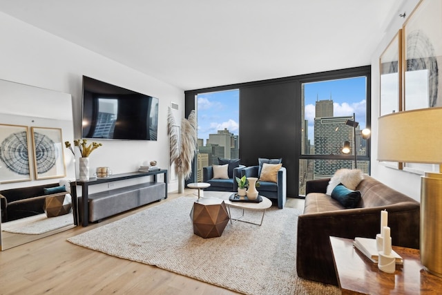 living area with expansive windows and wood finished floors