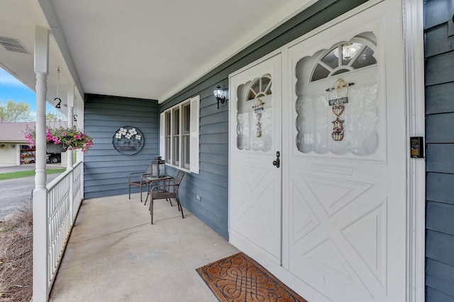 property entrance with visible vents and covered porch