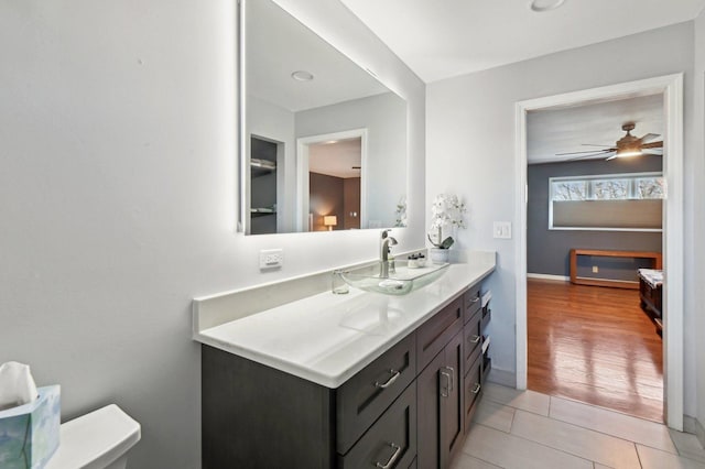 bathroom featuring a ceiling fan, tile patterned floors, baseboards, and vanity