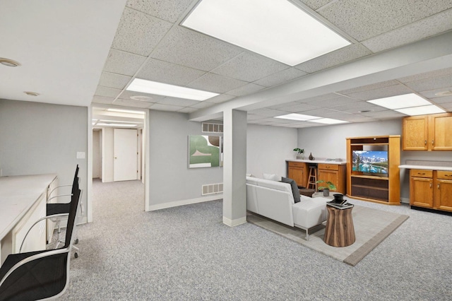 office featuring baseboards, visible vents, light carpet, and a drop ceiling