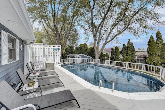 view of pool with fence, a fenced in pool, and a deck