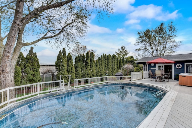 view of swimming pool featuring fence, a fenced in pool, a wooden deck, and outdoor dining area