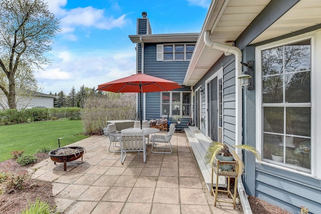view of patio / terrace with outdoor dining area and a fire pit