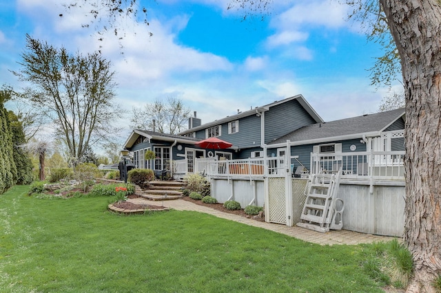 back of property featuring a lawn, a wooden deck, a chimney, and stairs