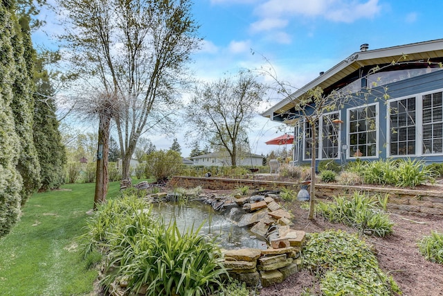 view of yard featuring a garden pond