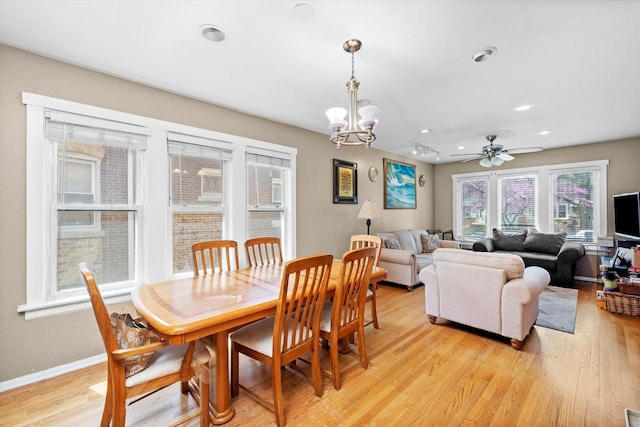 dining area featuring baseboards, ceiling fan with notable chandelier, recessed lighting, and light wood-style flooring