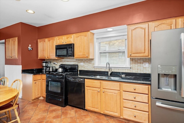 kitchen featuring a sink, decorative backsplash, light brown cabinetry, and black appliances