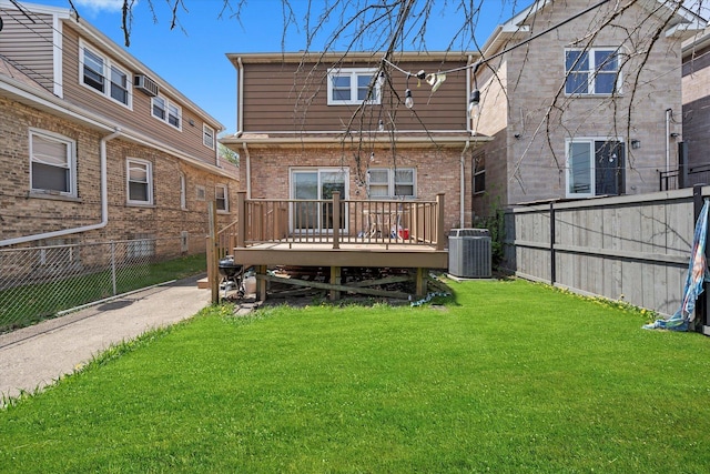 back of house with a lawn, fence, and a deck