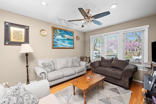 living room featuring a ceiling fan, recessed lighting, track lighting, and wood finished floors
