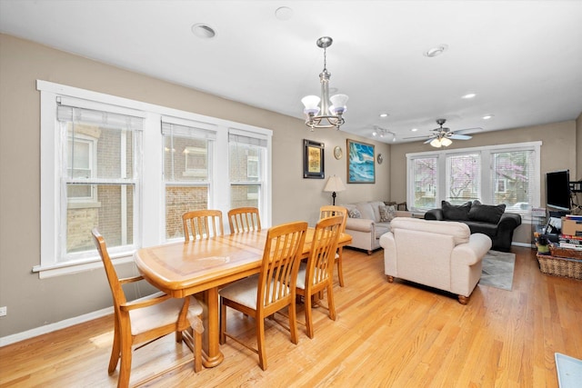 dining room with recessed lighting, baseboards, ceiling fan with notable chandelier, and light wood-type flooring