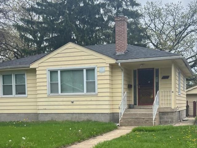 14535 Minerva Ave, Dolton, IL 60419 - view of front facade with a chimney, a front lawn, and a shingled roof