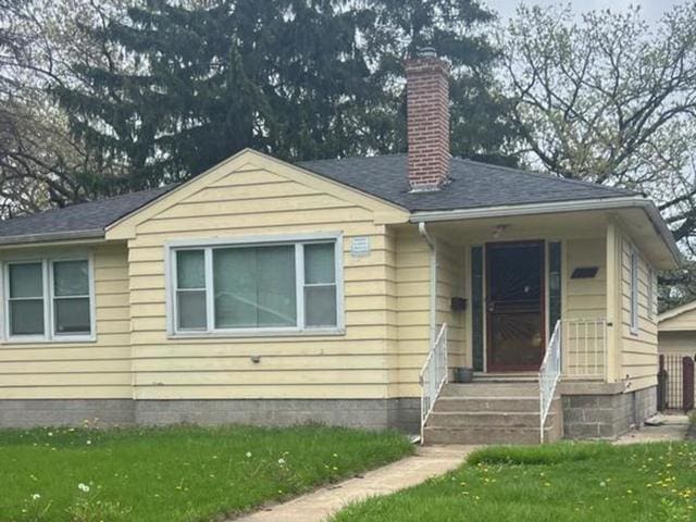 14535 Minerva Ave, Dolton, IL 60419 - bungalow-style home with a front yard, a chimney, and a shingled roof