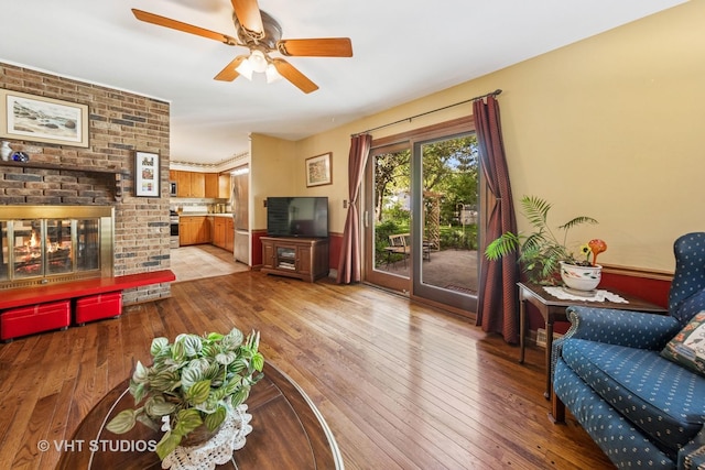 1525 Swallow St, Naperville, IL 60565 - living room with light wood-type flooring, ceiling fan, and a fireplace