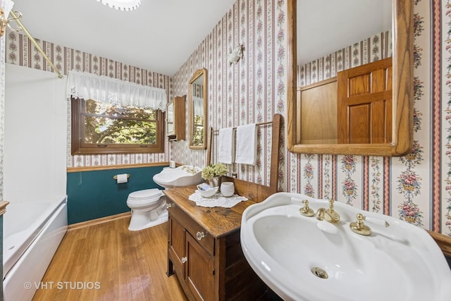 1525 Swallow St, Naperville, IL 60565 - full bathroom featuring wallpapered walls, a sink, wood finished floors, a tub, and toilet