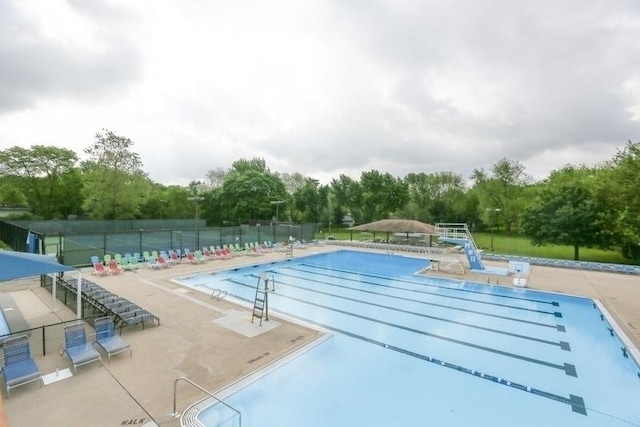 1525 Swallow St, Naperville, IL 60565 - community pool with fence, a patio, and view of scattered trees