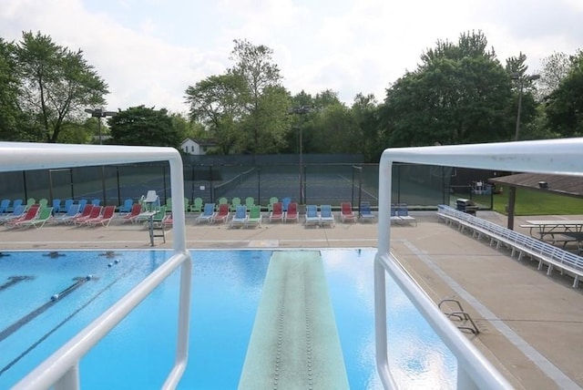 1525 Swallow St, Naperville, IL 60565 - community pool featuring a patio area and view of wooded area