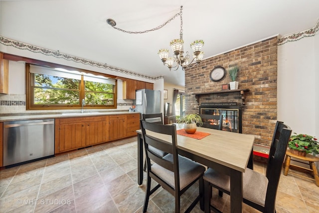 1525 Swallow St, Naperville, IL 60565 - dining space with stone finish flooring, a chandelier, and a fireplace
