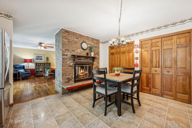 1525 Swallow St, Naperville, IL 60565 - dining room featuring a ceiling fan, a chandelier, a fireplace, and stone finish flooring