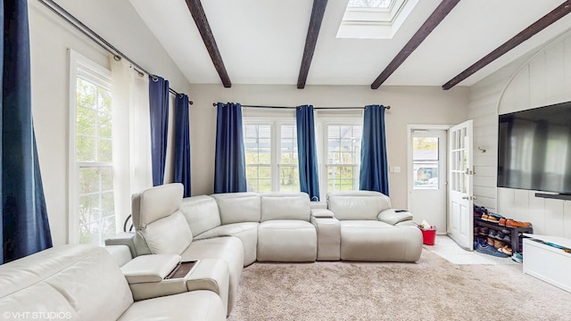 living room featuring carpet flooring and lofted ceiling with skylight