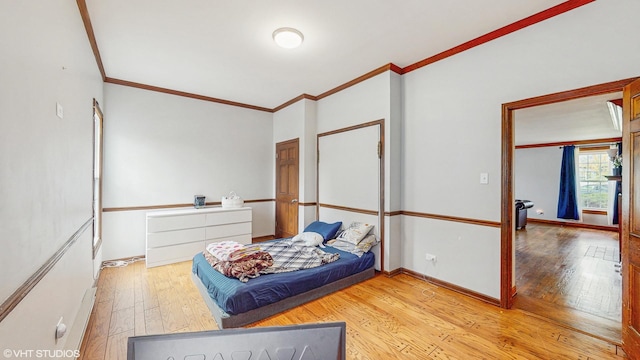 bedroom featuring crown molding, baseboards, and wood-type flooring