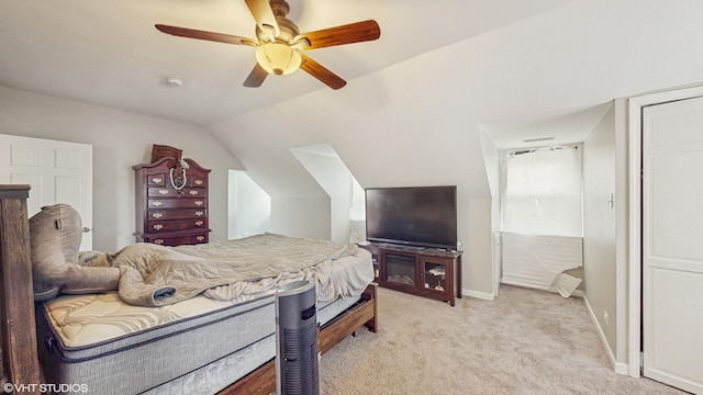 bedroom with a ceiling fan, baseboards, light carpet, and vaulted ceiling