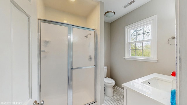 bathroom with visible vents, tile patterned flooring, a stall shower, vanity, and toilet