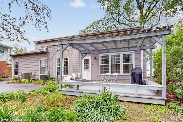 back of house featuring a pergola, central AC, and a deck