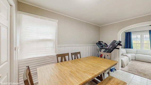 tiled dining area featuring ornamental molding