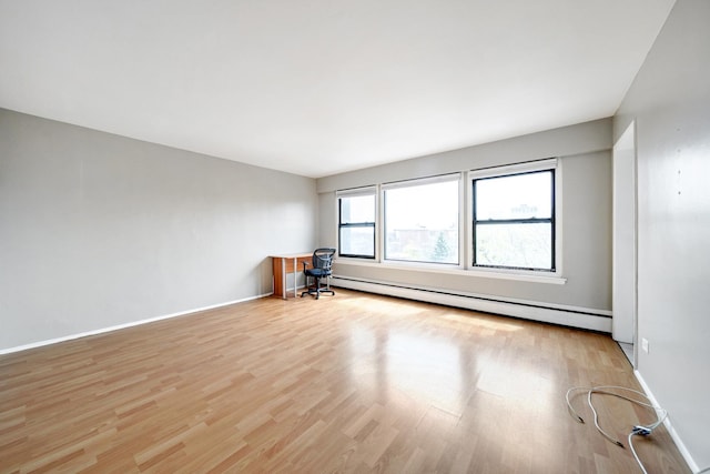 4880 N Marine Dr Unit 614, Chicago, IL 60640 - empty room with baseboards, a baseboard radiator, and light wood-style flooring
