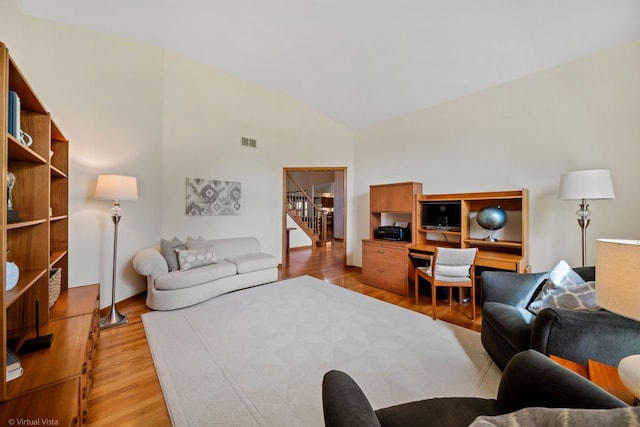 396 Crestwood Rd, Wood Dale, IL 60191 - living area featuring light wood-style floors, stairs, and high vaulted ceiling