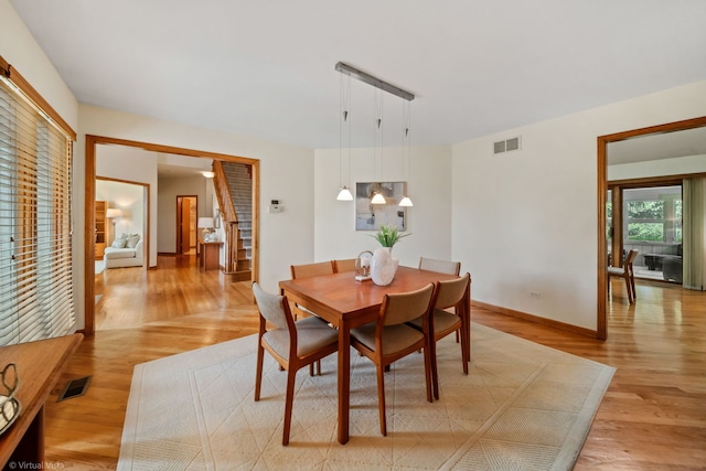 396 Crestwood Rd, Wood Dale, IL 60191 - dining area with light wood-style floors, baseboards, and stairs