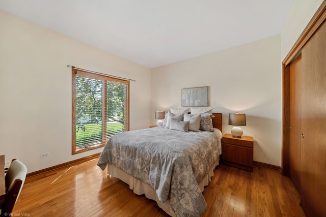 396 Crestwood Rd, Wood Dale, IL 60191 - bedroom featuring hardwood / wood-style flooring, baseboards, and a closet